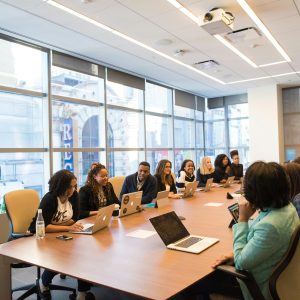 A diverse team of business professionals collaborating in a modern meeting room.